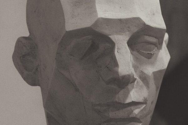 gray concrete face bust on white surface