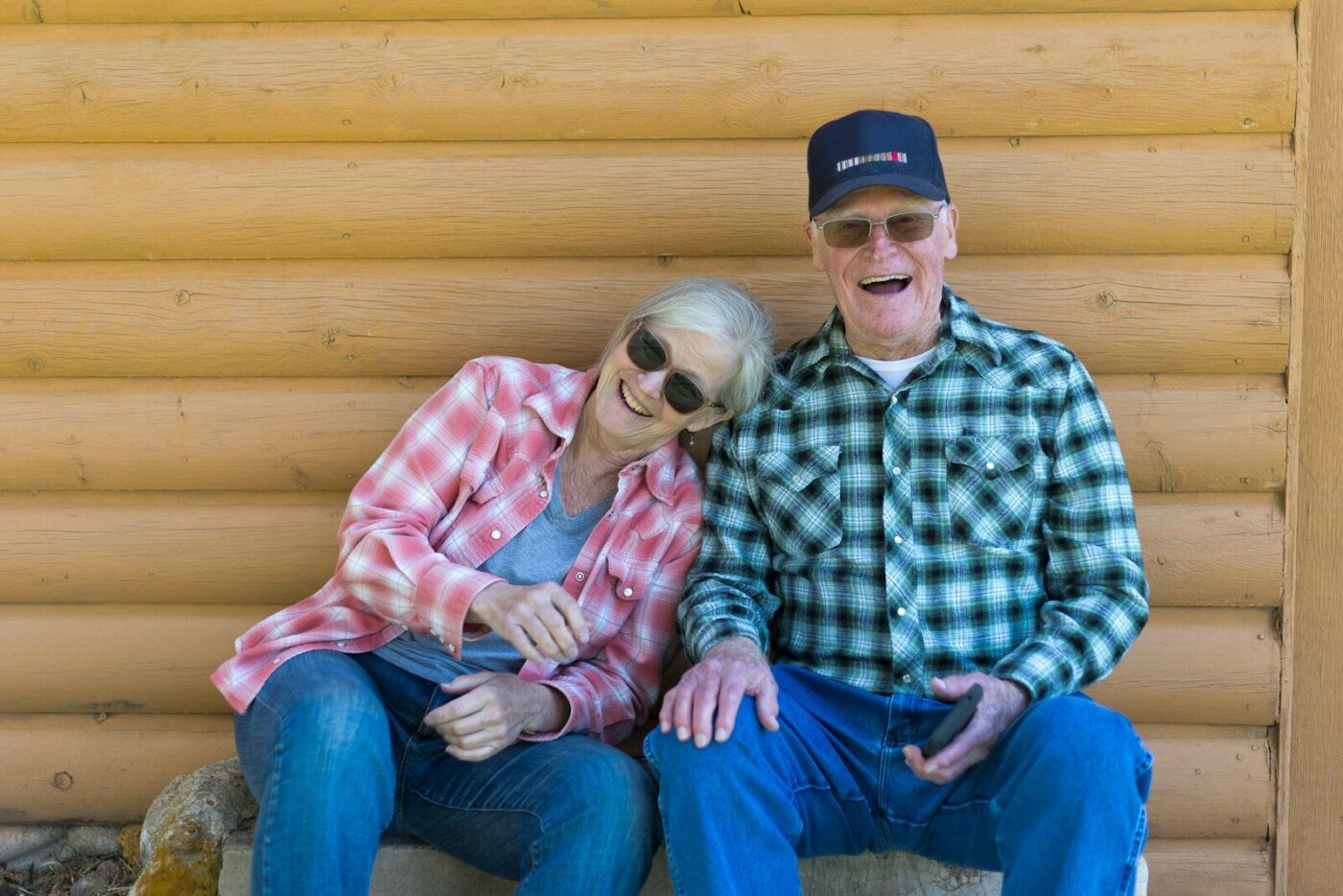 Elderly couple sitting together outdoors
